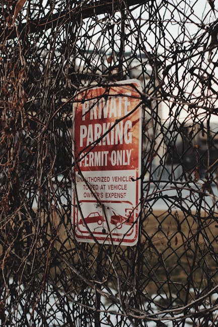A vertical street sign post mounted outdoors with three rectangular signs warning against parking and stopping restrictions in Haringey. The top sign is red and white, indicating a tow-away zone with 